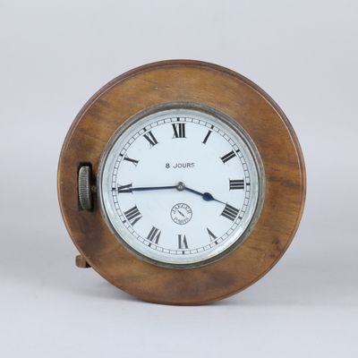 a wooden clock with roman numerals on the face
