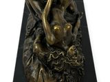bronze statue of a woman holding a baby on a black marble base