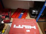 a red box sitting on the floor next to a shelf