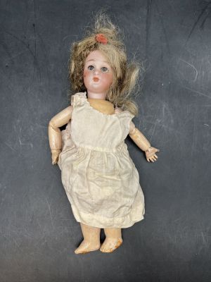 a doll that is laying down on a black surface