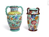 two colorful vases with handles are sitting side by side on a white surface