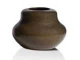 a brown vase that is sitting on a white surface