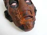 un gros plan d'un masque posé sur une surface blanche