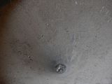 a close up of a person ' s hand holding a silver object