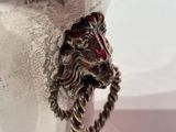 a silver vase with a lion head on it