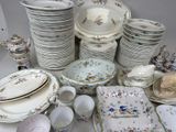 many plates and bowls and cups on the table