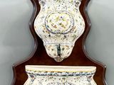 pair of wall sconces in the shape of vases on a wall