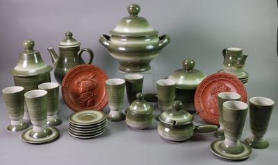 a lot of green and white dishes and cups on the table