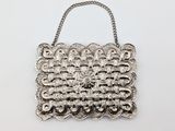 a silver purse with a chain strap and a clasp