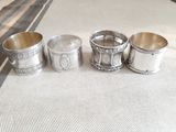 three silver cups are lined up on a table next to each other