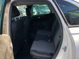 the back seat of a car with the door open and the passenger seat down