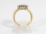 a gold ring with three diamonds on top of it