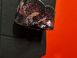 a close up of a black jacket with a flower on it