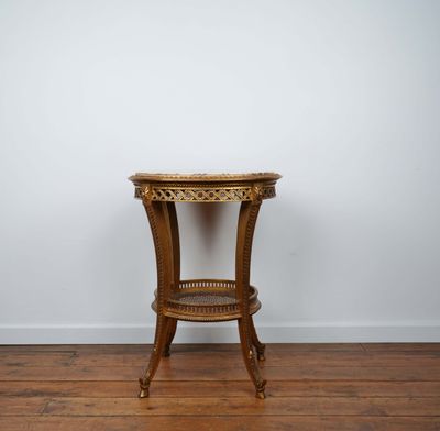 an old wooden table with a glass top on a hard wood floor