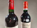 two bottles of wine sitting next to each other on a table