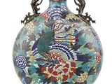 a vase with a bird on it on a white background