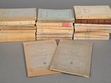 several old books stacked on top of each other on a table