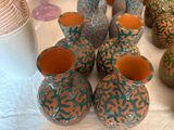 many vases that are sitting on a table