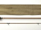 two fishing rods and a fishing rod on a white surface