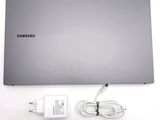 a silver laptop with a charger and a charger plugged into it