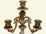 a candle holder that has three candles on top of it