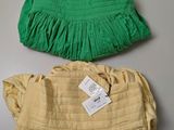 pair of yellow and green handbags with tags on them