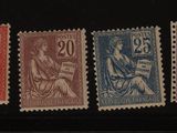 quatre timbres-poste de couleurs différentes sur fond noir