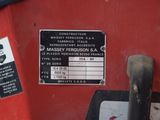 a close up of a sign on a red tractor