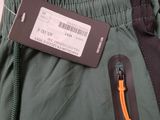 the back of a pair of green pants with a tag on it