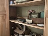 a closet with a lot of boxes and boxes on the shelves