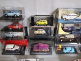 a lot of toy cars that are in a display case