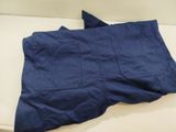 navy blue pants on a white couch with a blue pillow