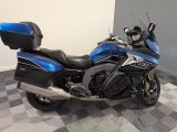 a blue and black motorcycle parked on a checkered floor