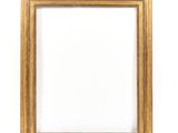 a gold frame on a white wall with a white background