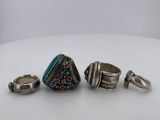 a group of silver rings and a ring with a turquoise stone
