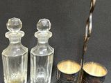 three glass bottles and a spoon sitting next to each other on a table