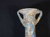 a very old vase that is sitting on a table