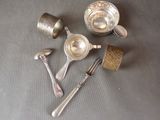 a lot of silver spoons and forks on the table