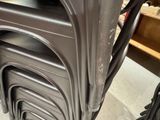 a lot of chairs that are stacked on top of each other