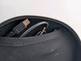 a black bag with a charger and a cable in it