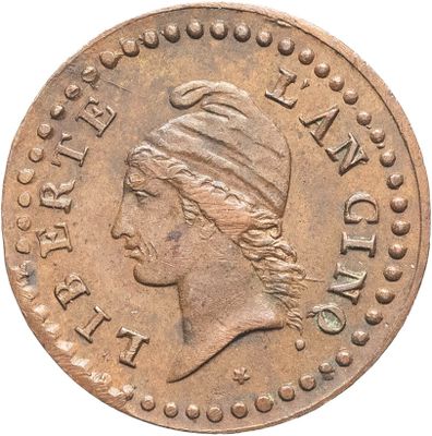 gros plan d'une pièce de monnaie sur laquelle figure une tête de femme
