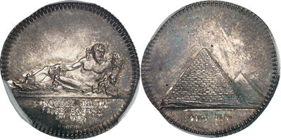 an image of a silver coin with an image of a woman and a pyramid on it