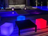 several different colored cube lights are lit up on a deck