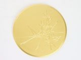 a gold medal with a picture of a ship on it