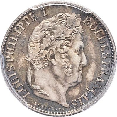 a silver coin with a woman ' s head on it