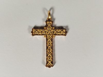 an image of a gold cross on a white surface