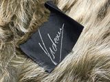 a close up of a fur coat with a label on it