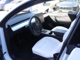 a white car with a black steering wheel and a white seat