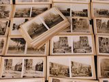 a lot of old black and white photos on the table