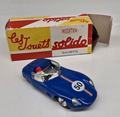 a toy car that is sitting next to a box of cigarettes